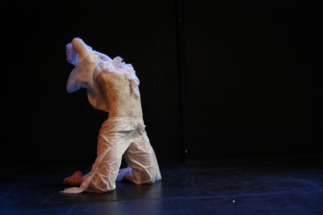 A female dancers executes a back end on her knees